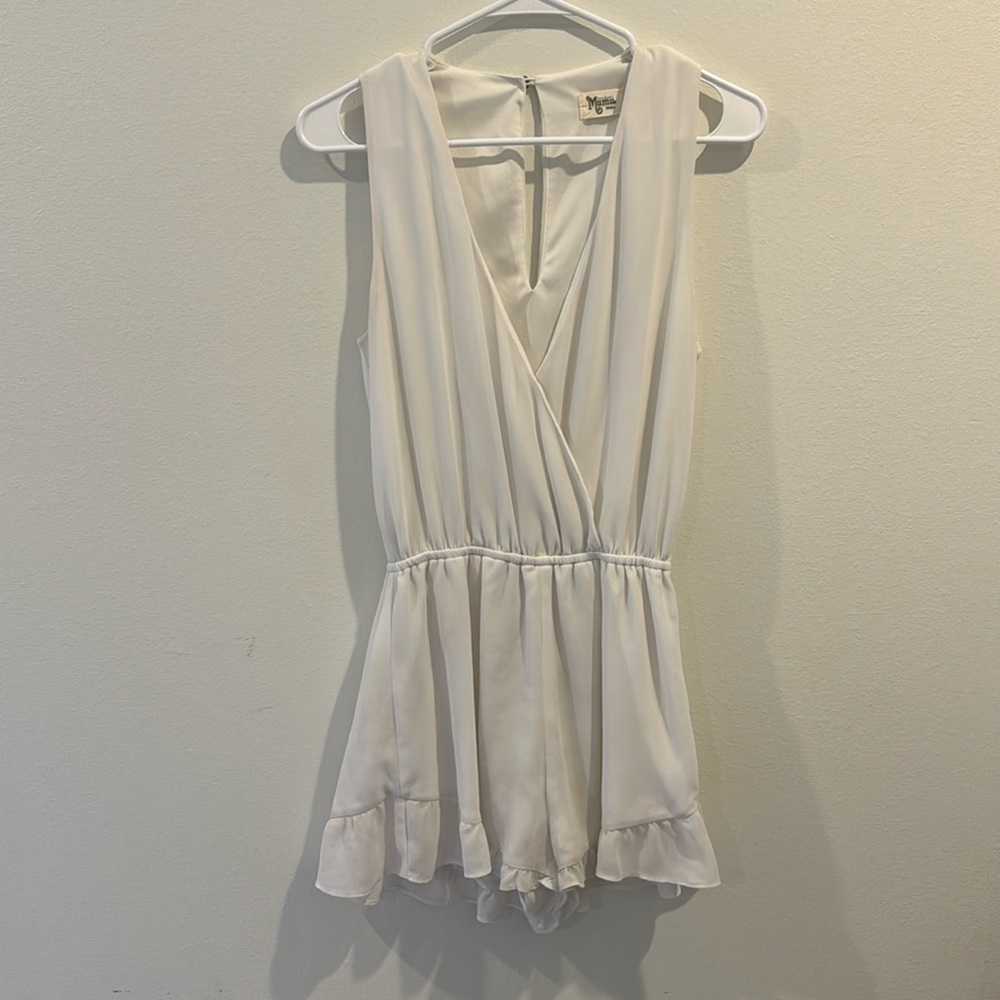 Show me your MuMu white sleeveless romper with ruffled shorts